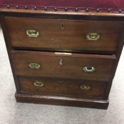 A Unusual small campaign style three drawer gun chest with red Leather seat