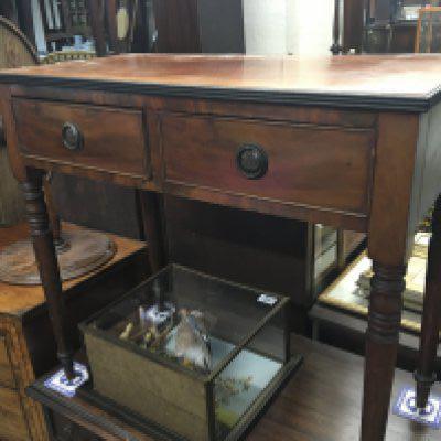 An Early Victorian mahogany side table with two drawers on ring turned legs. 77cm wide 39cm deep.