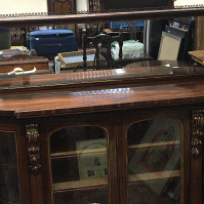 A Quality Early Victorian Walnut credenza with a raised mirrored back with gilded pillar supports above glazed doors with glazed bowed glass ends in very good original condition.158cm long height 135cm 48cm deep.