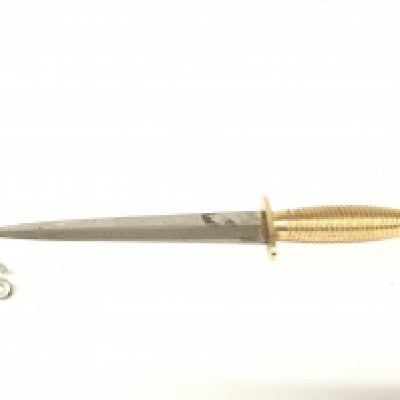 A vintage Faibairn Sykes design commemorative Commando dagger by R.Cooper, Sheffield along with a vintage Commando cap badge. This lot cannot be posted