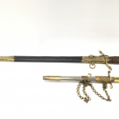 A reproduction Bulgarian army dagger (34cm long 25cm long blade) and Repro Naval Officers Dirk with leather grip, brass lion head pommel, acorn cross guard. Total length 64cm ,blade 50cm . Cannot be posted