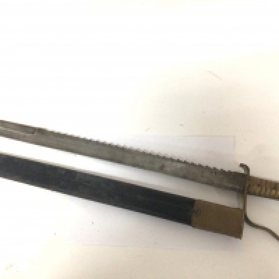 A 19th Century Pioneer 1856 pattern bayonet sword with saw edge blade made by Wilkinson and with further military stamps to the blade.