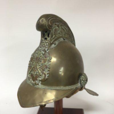 A Victorian brass fireman&rsquo;s helmet replacement strap.