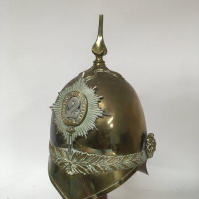 A Victorian British Military brass Cavalry helmet 1871 pattern with bade of the second battalion Dragoon Gaurds. Lacking plume and chin strap and strap side fixing buckle.