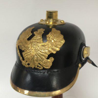 A reproduction German I world war Pickelhaube helmet.with brass fittings on leather.
