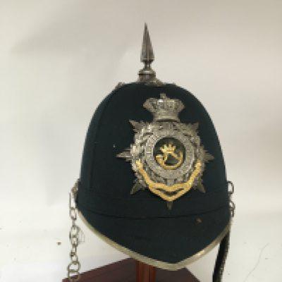 A Victorian Military helmet the interior with makers label the shako helmet plate of the Somersetshire light infantry. Considered to be all original.