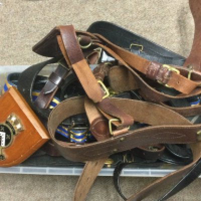 A collection of leather belts including a Gieves Royal Navy leather belt , Peal & Co London brown leather officers belt etc. postage category C