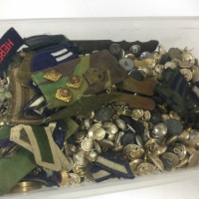 A collection of military uniform buttons, cap badges etc. postage category B