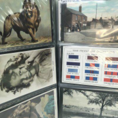 An album of early British postcards including some local interest cards, postage category C