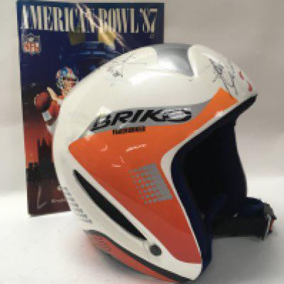 A singed American football helmet together with a official program Los Angeles Rams v Denver Broncos . NO RESERVE