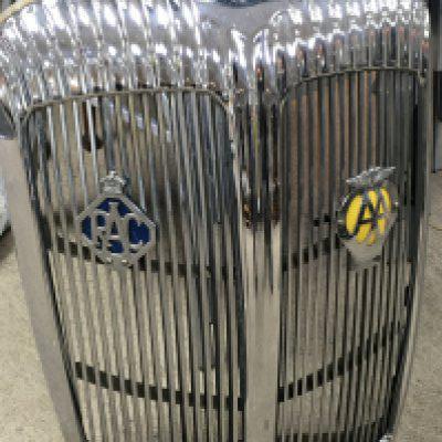 A vintage Daimler grill with R.A.C. and AA badges. 62cm tall. This lot cannot be posted