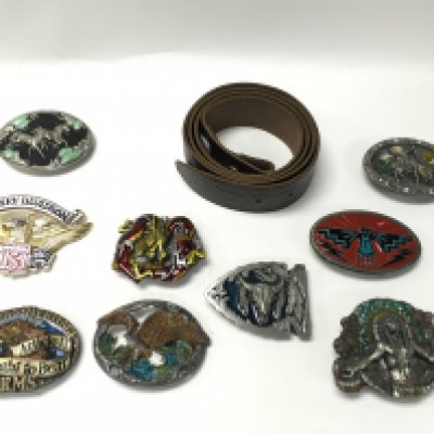 A collection of 9 belt buckles with a new leather belt. Postage B. NO RESERVE