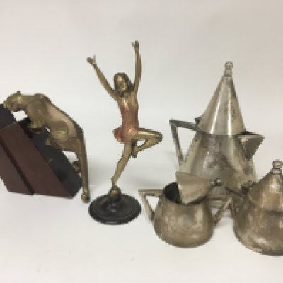 An Art Deco cast figures of a leopard a dancing figure and a modern design silver plated tea set.