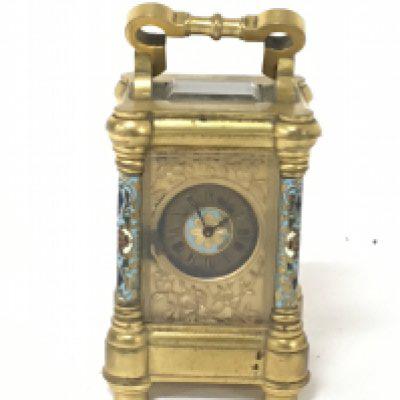 A Quality miniature gilt metal and enamel decorated Carriage clock with raised floral decoration Height 8cm with outer box and key not seen working.