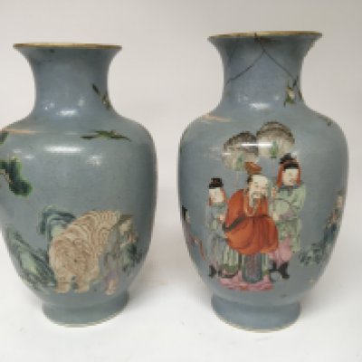 A Pair of Chinese Export porcelain vases. With four caricature marks Yongzheng 1723-1736. Considered to be of the period. The vase with a pale patterned ground decorated with a senior elder or Emperor flanked by further figures.one figure Presenting a scroll. With rock and animal figures and trees. Unfortunately with damage chips and cracks to the body see images. Height 33cm