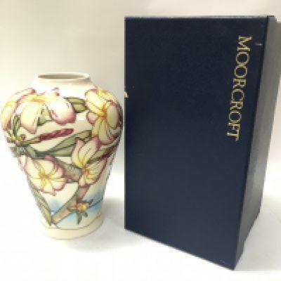 A boxed Moorcroft Frangipani vase, 22cm tall. No obvious large damage or restoration. This lot cannot be posted
