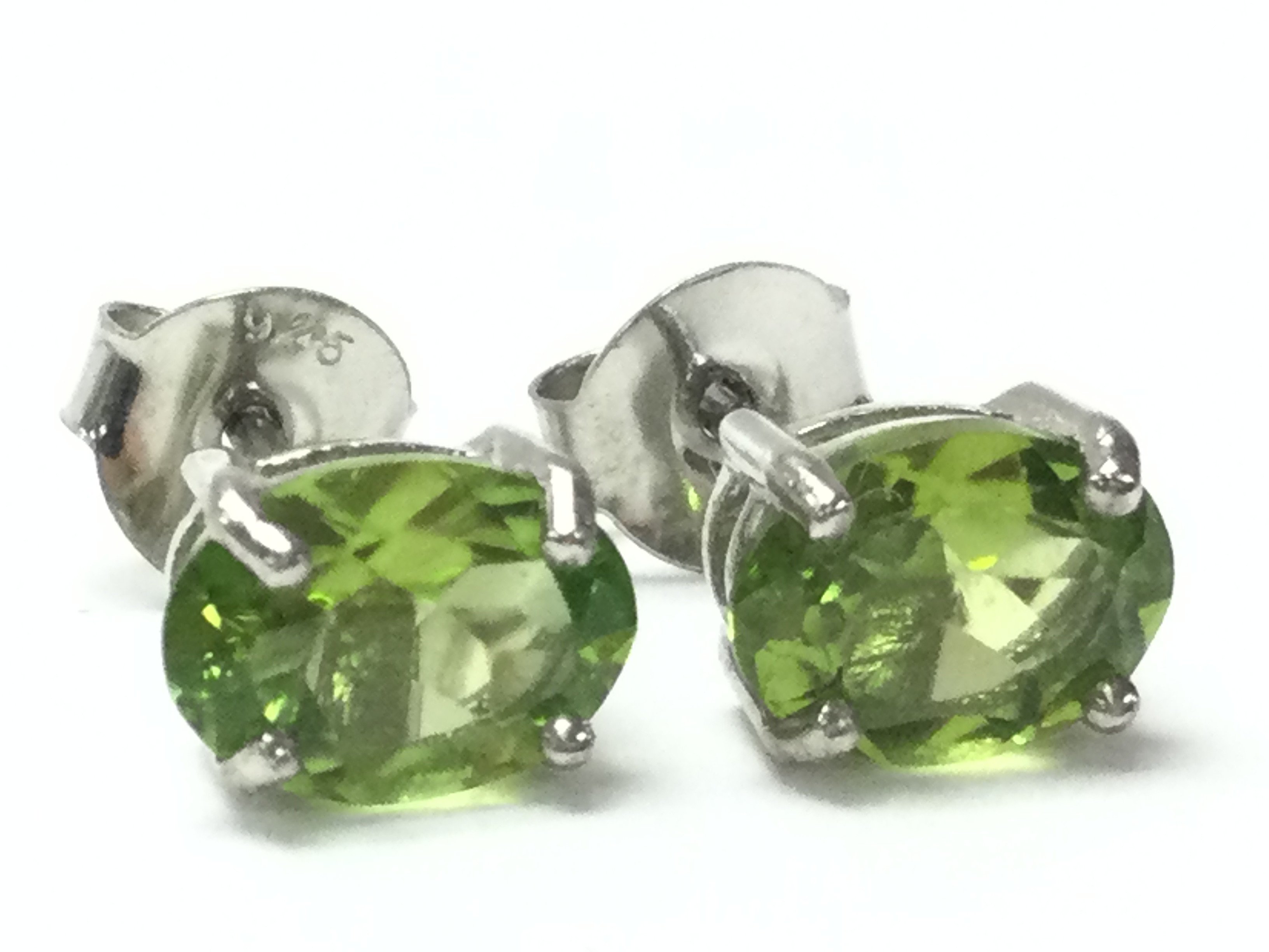 A pair of Peridot studs in silver , postage category A