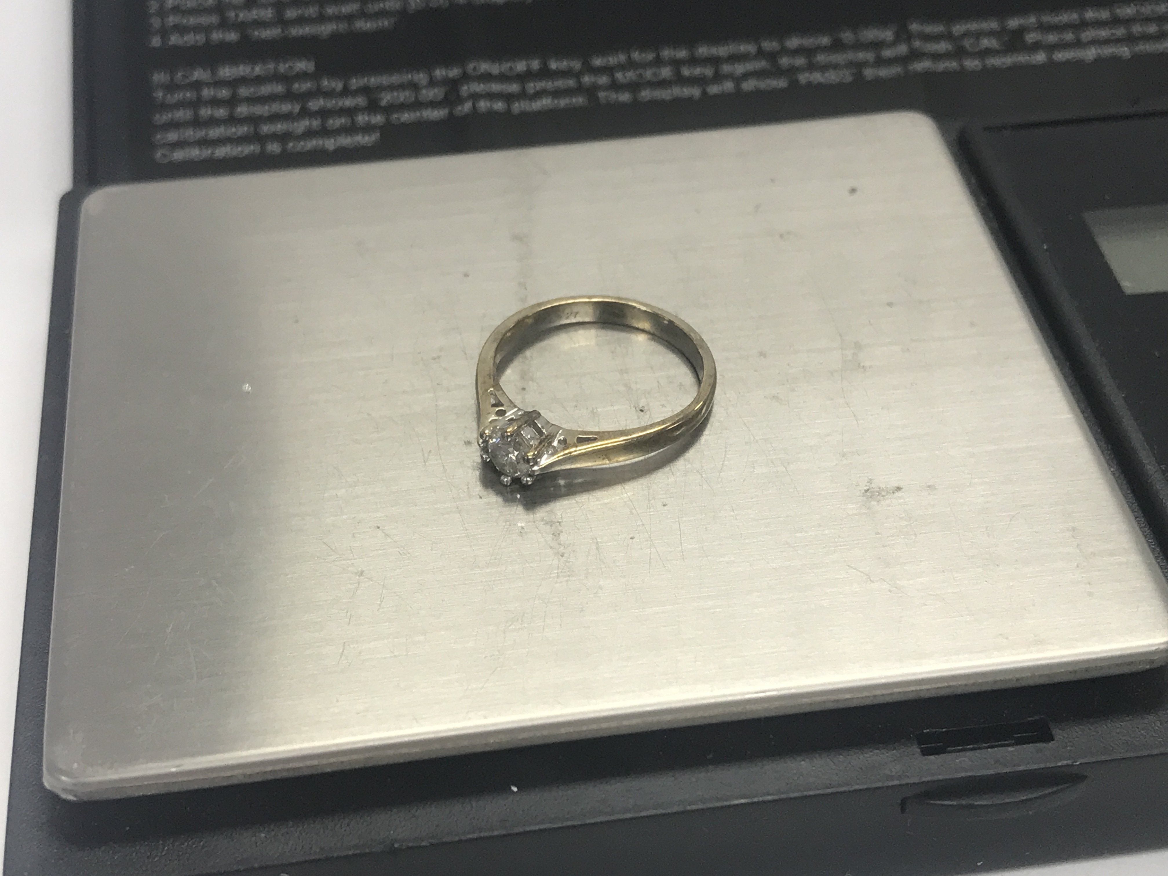 A 9ct gold diamond solitaire ring 27pts, approx 2 grams, size J.