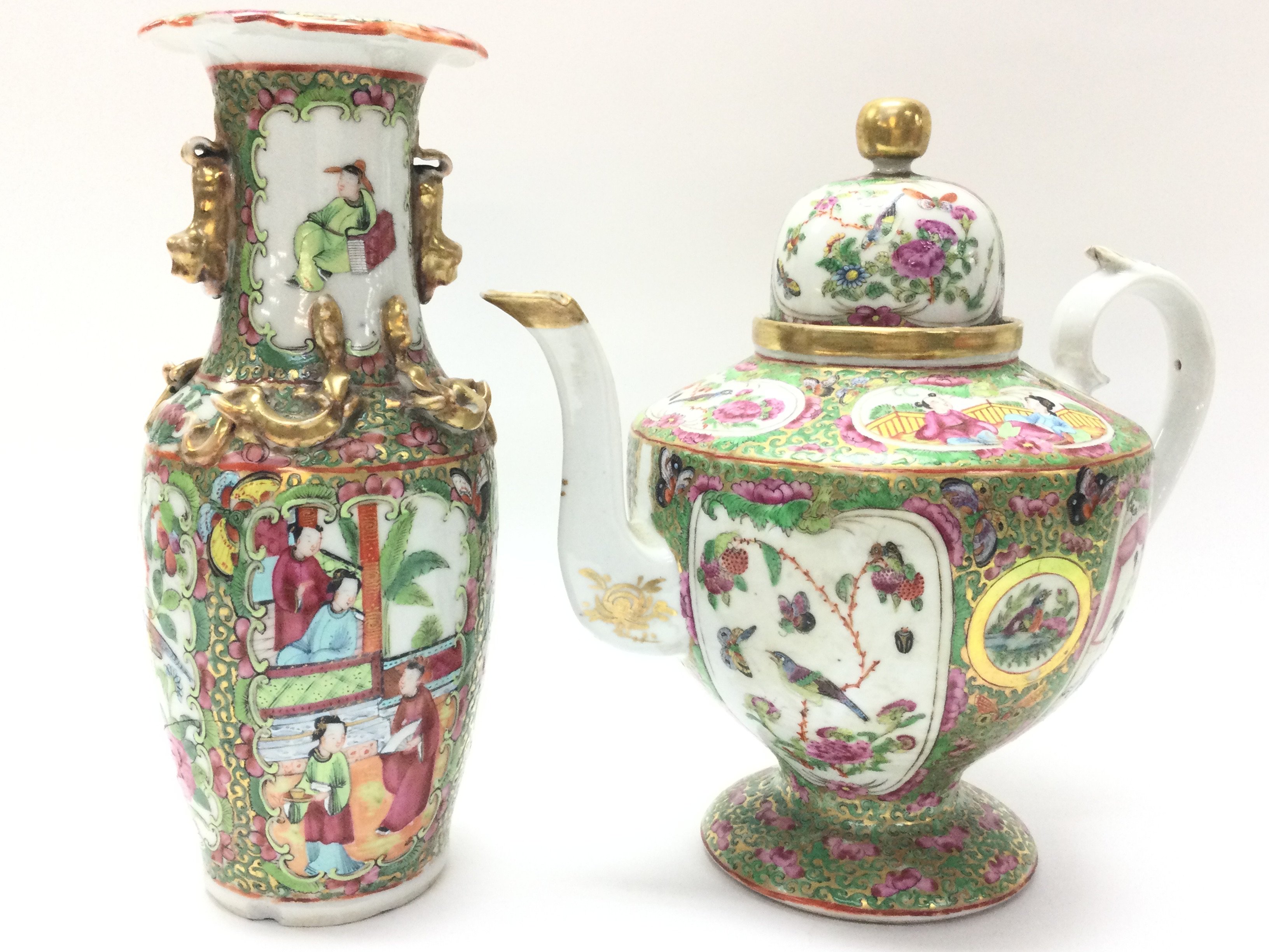 A Cantonese Famille Rose tea pot and vase. Chips at the rim of the vase and at the base. Approximately 25 & 24cm tall. Postage category D