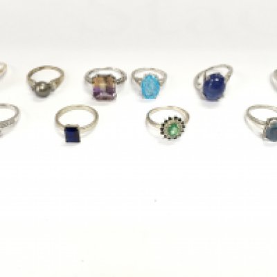 A collection of 10 assorted silver rings set with various stones. Postage B