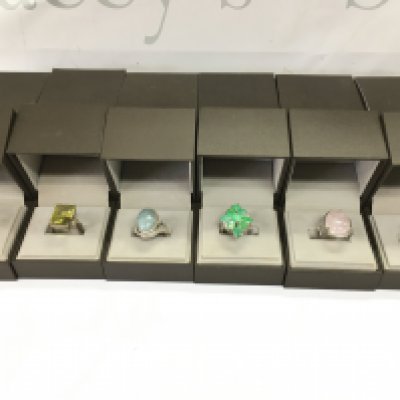 A collection of 6 assorted silver rings set with various stones. Postage B
