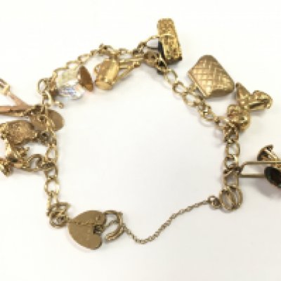 A 9ct gold charm bracelet, total weight 16.4g. Postage category A