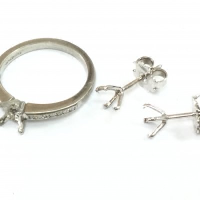 A platinum ring set with small diamond shards (3.8g) and a pair of 18ct white gold earrings (1g) .