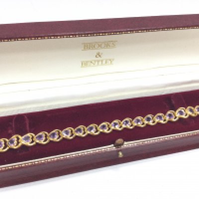 A silver gilt Amethyst heart bracelet. Postage category A