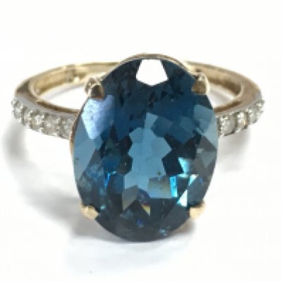 A 9 carat gold blue topaz stone and diamond set ring , 4.5g total weight. Size S. Postage category A