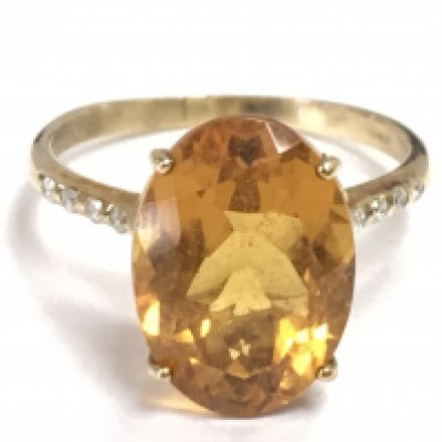 A 9 carat gold solitaire citrine set with small diamond stones, size Q. 3.4g total weight Postage category A