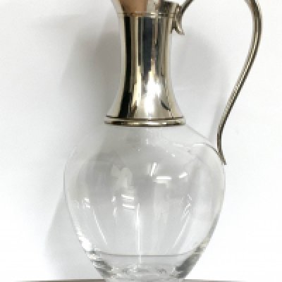 A modern hallmarked silver mounted glass claret jug and stopper with scroll handle, London 1998, height 30.5cm. (D)