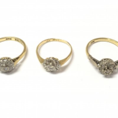 Three 18ct diamond cluster rings. 7.54g Postage A