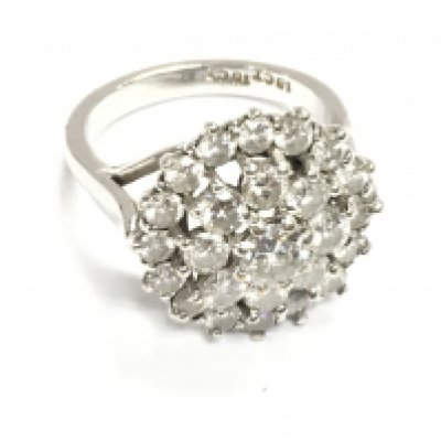 An 18ct white gold diamond cluster ring. Size N and 8.15g Central diamond is approximately 0.50ct and approximately 3.2ct total in diamonds
