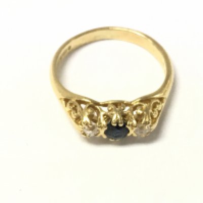 An 18ct gold sapphire and diamond three stone ring. Size L and 3.35g Postage A