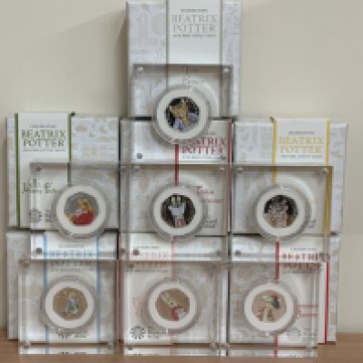 7 Royal Mint Beatrix Potter cased coloured silver 50p coins to include 2017 Tom Kitten, 2017 Jeremy Fisher, 2018 Peter Rabbit, 2018 The Tailor Gloucester, 2018 Flopsy Bunny, 2018 Mrs Tittlemouse, 2017 Benjamin Bunny. (B)