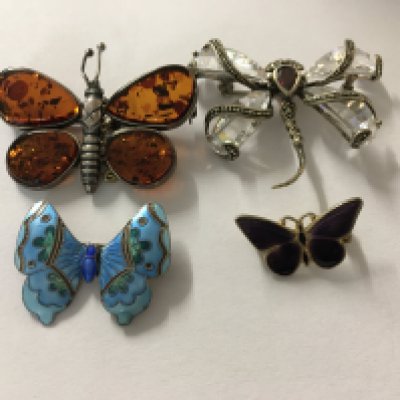 A collection of four Butterfly, dragonfly brooches , including enamel .