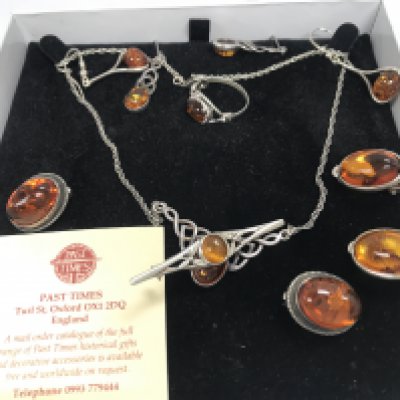 A Collection of silver and amber jewellery including a necklace, earrings , ring . Postage category a