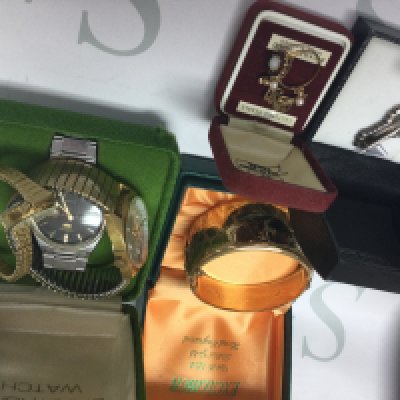 A gold ring dress watches and a gold tone bangle .