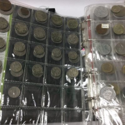 A box containing cased Royal mint Proof coin collections together with two albums of British and world coins .