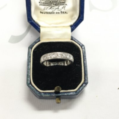 A platinum eternity ring set with diamonds. Approx weight 4.53 grams, size L.