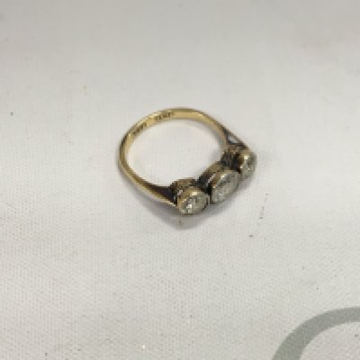 An 18ct gold and platinum three stone old cut diamond ring. Approx weight 2.95 grams, size N.