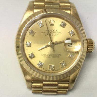 A rolex lady Datejust with diamond markers. 18k gold case and strap. 26mm. Watch winds and runs. Comes with box and paperwork including when vendor purchased from beaverbrooks in 2016. Watch is circa 1988.