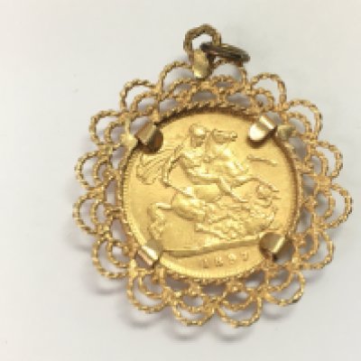 An 1897 half Sovereign in a 9ct gold mount. 6.24g Postage A