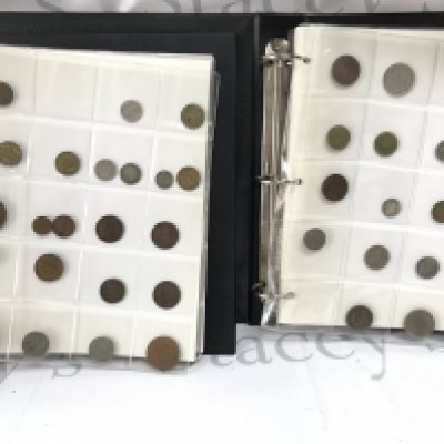 Two albums containing various circulated world coinage. Postage B