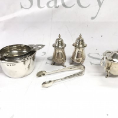 A Collection of silver items including a tea strainer a set of tongs and a condiment set. Total weight approx 205g