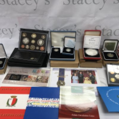 A collection of coin sets and silver proof coins.