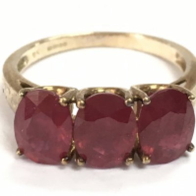 A 9ct gold ruby set three stone ring, R/S. 4.2g total weight. postage catA
