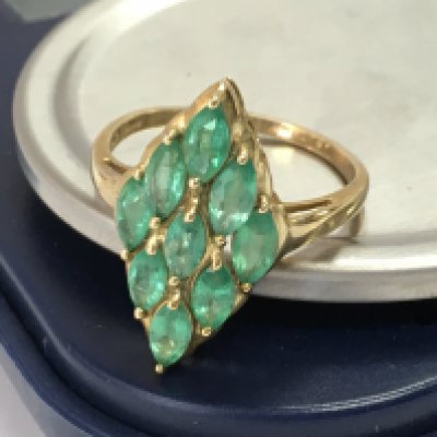 A 9ct gold art deco style ring set with green gemstones , size Q. postage category A