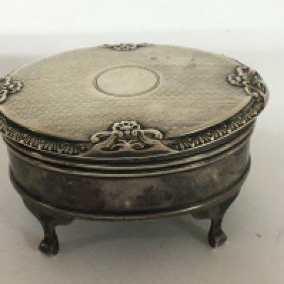 A silver oval shaped ring box 7.5cm diameter with a lined interior. Birmingham hallmarks.