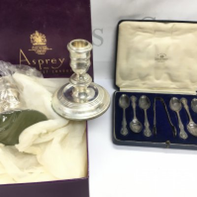 A pair of boxed Asprey hallmarked candlesticks and a cased set of Mappin and Webb silver spoons. Postage B
